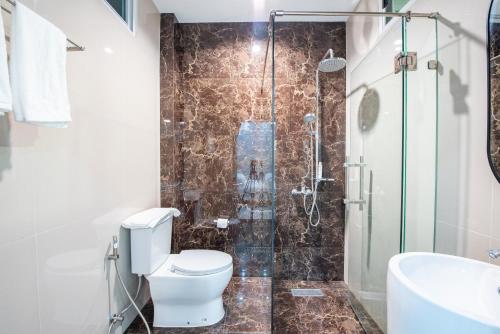 a bathroom with a toilet and a shower at Tidal Coast Villa Pattaya in Ban Huai Yai