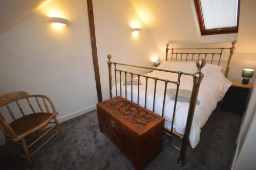a bedroom with a metal bed and a chair at Central 1-Bed - Sleeps 2 - Pet Friendly w Garden in Hopton Wafers