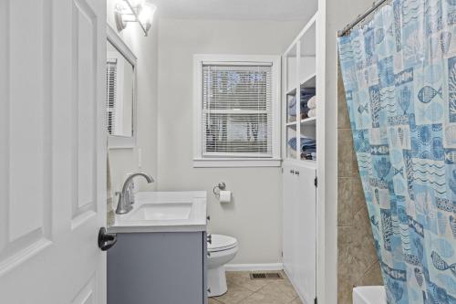 a white bathroom with a sink and a toilet at P Js Inlet - Pet Friendly Oasis in Lavonia