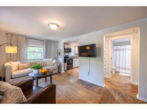a living room with a couch and a table at Downtown Bungalow Less than 1.5 Miles to UGA in Athens