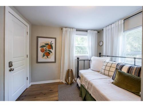 a living room with a couch and a window at Downtown Bungalow Less than 1.5 Miles to UGA in Athens