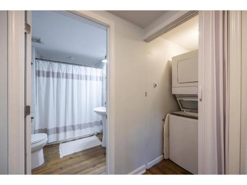 a bathroom with a toilet and a sink and a window at Downtown Bungalow Less than 1.5 Miles to UGA in Athens