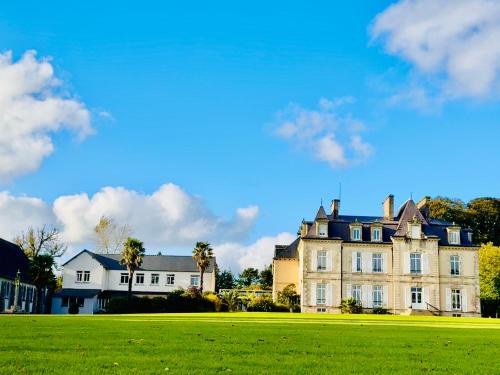 a large house with a green field in front of it at Hébergement Centre Missionnaire Saint Jacques in Guiclan