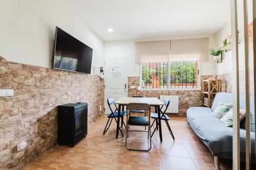 a living room with a table and a couch at Casa Las 4 Estaciones in Caudiel