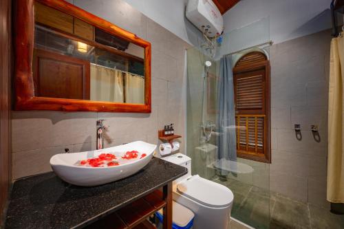 a bathroom with a sink and a toilet at Hoianbang Beach Front Villa and Restaurant in An Bang