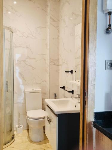a bathroom with a toilet and a sink at BenHost Appartement Casablanca Maarif in Casablanca