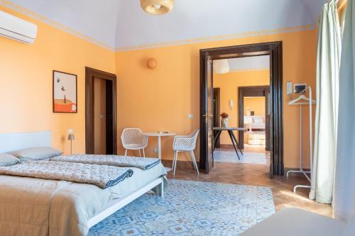 a bedroom with a bed and a table and chairs at Casa Castanea in Trecastagni Catania in Trecastagni