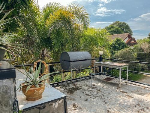 a patio with a table and a gas tank at BaanMee Phuket near Chalong Pier in Chalong 