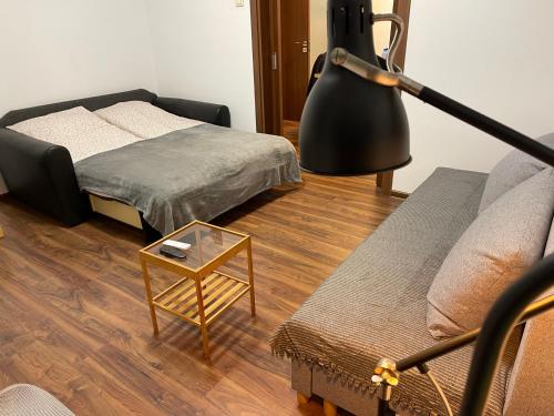 a living room with a bed and a lamp at Cinema house at Sofia center in Sofia