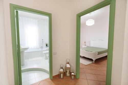 a bathroom with a mirror and a bed and a tub at House Marisa 5 minutes from the airport in Casoria