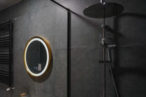 a bathroom with a mirror and a shower at Camp Hotel Pura Vida in Tbilisi City