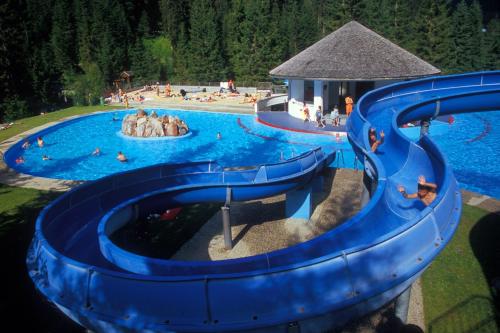 a blue water slide at a water park at Nexus Suiten - by A-Appartments in Stuben am Arlberg