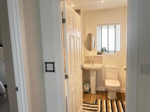 a bathroom with a toilet and a sink at 4 Bed House - Sleeps 7 - Pets - Parking - Wifi in Bushbury