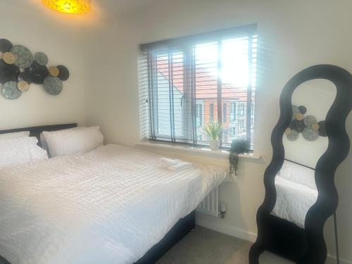 a bedroom with a bed and a window at 4 Bed House - Sleeps 7 - Pets - Parking - Wifi in Bushbury