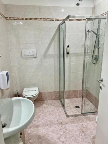 a bathroom with a shower and a toilet and a sink at Il Grifo Hotel e Bisteccheria Toscana in Montepulciano