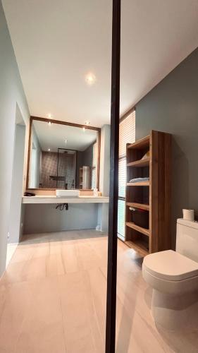 a bathroom with a toilet and a mirror at Private pool villa Siargao La residence in General Luna