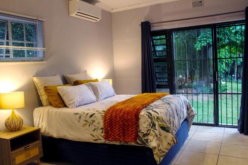 a bedroom with a bed and a large window at Newcastle Country Retreat in Newcastle