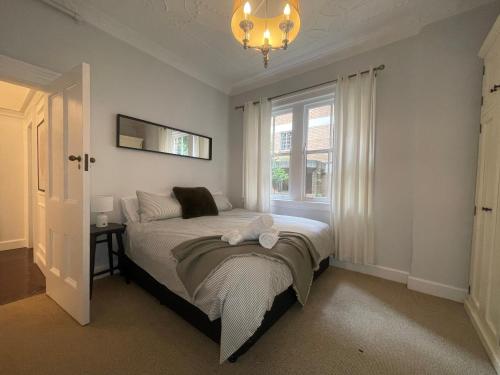 a bedroom with a bed and a window at Luxury heritage Hideaway - close to CBD! in Sydney