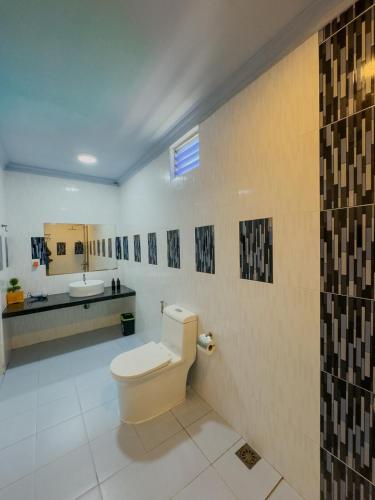 a bathroom with a toilet and a sink at Ari Stay Thoddoo in Thoddoo