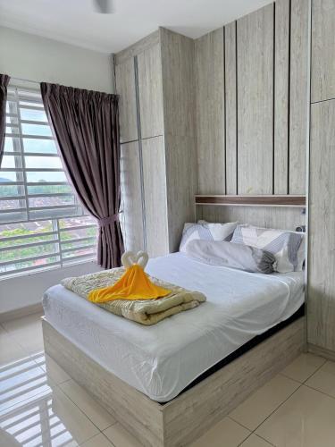 a bedroom with a large white bed with a window at Kalista1 Seremban 2 in Seremban