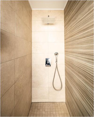 a bathroom with a shower with a shower head at Hôtel Cala di Sole in Ajaccio