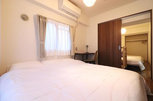 Postel nebo postele na pokoji v ubytování Cafune NAGOYA - Perfect for sightseeing in Nagoya and long-term stays! 3LDK with parking lot