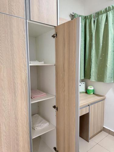 a room with a closet with a door open at Kalista1 Seremban 2 in Seremban