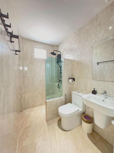 a bathroom with a toilet and a shower and a sink at The Pinda House Bangtao in Bang Tao Beach