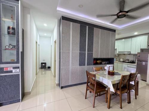 a kitchen with a table and chairs and a ceiling fan at Kalista1 in Seremban