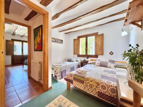 a bedroom with a bed and a table in a room at Hotel Rural Villa Liquidámbar in Torrecilla en Cameros
