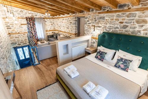 a bedroom with a bed and a couch in a room at Guesthouse Iris in Tsagarada