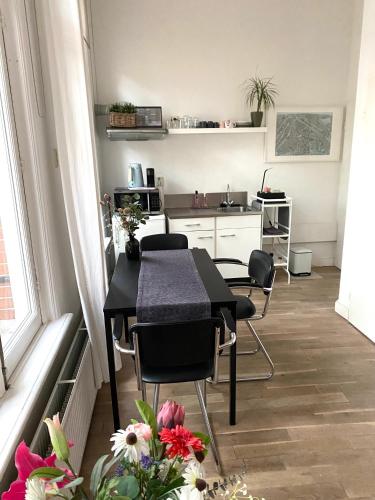 a table and chairs in a room with a kitchen at De Kardinaal in Den Bosch