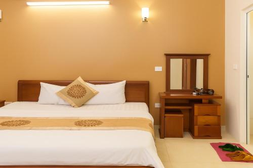 a bedroom with a bed and a table and a mirror at Love Hotel in Hanoi