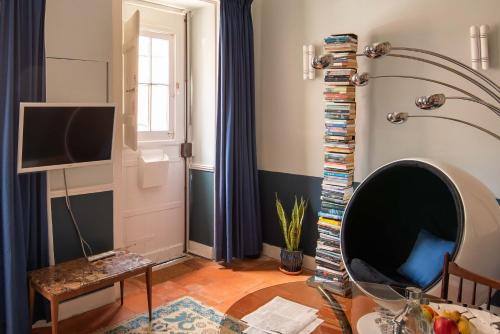 a living room with a tv and a table at CASA AMORA Studio Apartments in Lisbon