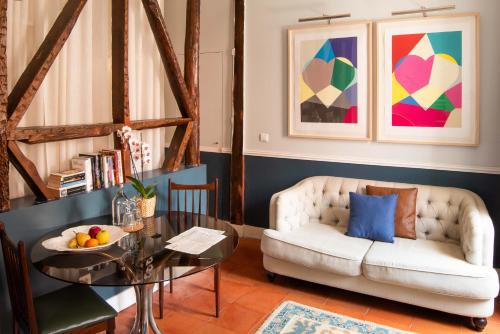 a living room with a couch and a table at CASA AMORA Studio Apartments in Lisbon
