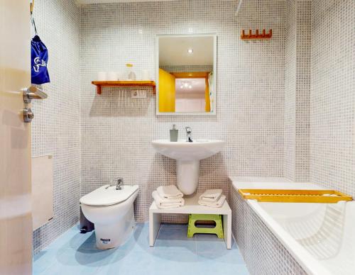 a white bathroom with a sink and a toilet at Apartamento en Alcala de la Selva by Family Homes in Alcalá de la Selva