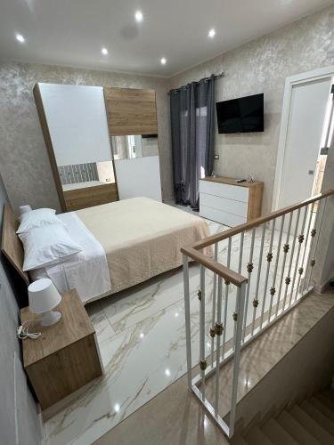 a bedroom with a large bed and a mirror at Testa House 2 0 in Catania