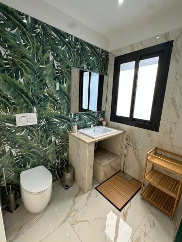 a bathroom with a sink and a large leaf wallpaper at Testa House 2 0 in Catania