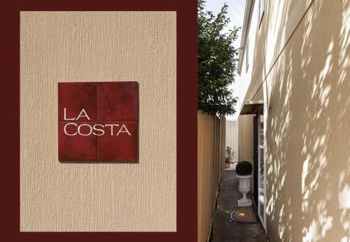 a sign that says la costaria on the side of a building at La Costa Shoal Bay in Shoal Bay