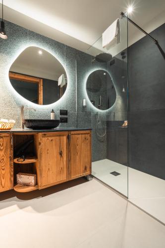 a bathroom with a sink and a mirror at Design Oberosler Hotel in Madonna di Campiglio