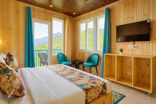 a bedroom with a bed and a flat screen tv at Nature Valley Cottage, Mussoorie in Mussoorie