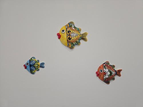 a group of three fish on a white background at Casetta Di Nonno Paolo in Contrada Mastrissa