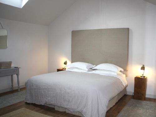 a bedroom with a large white bed with two lamps at 1 Bed in Ullswater 94068 in Watermillock