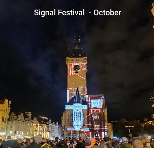 a crowd of people standing in front of a clock tower at Apartmány Podol in Prague