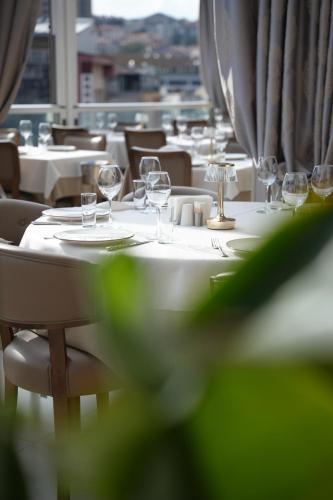 a long table with white tables and wine glasses at Gaia Suites Istanbul in Istanbul