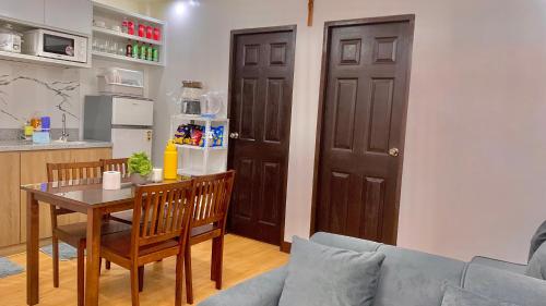 a living room with a table and a couch at MAYABO CONDO by Urban Deca Home Batangas in Batangas City