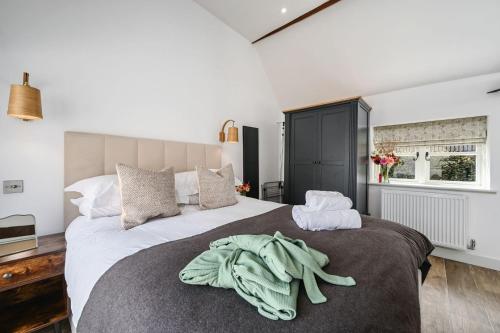a bedroom with two beds with towels on the bed at The Cow Shed in Groombridge