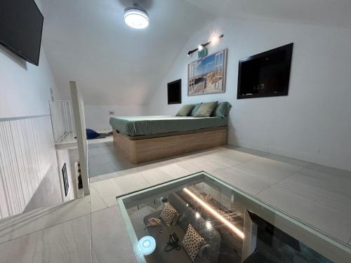 a living room with a couch and a fish tank at Carihuela Home in Torremolinos