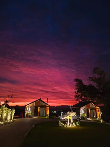a house at night with a red sky at Le Mont Chalés in Bento Gonçalves