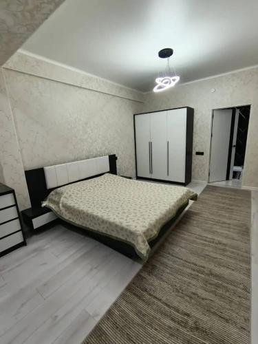 a bedroom with a large bed in a room at Urban oasis in Bishkek